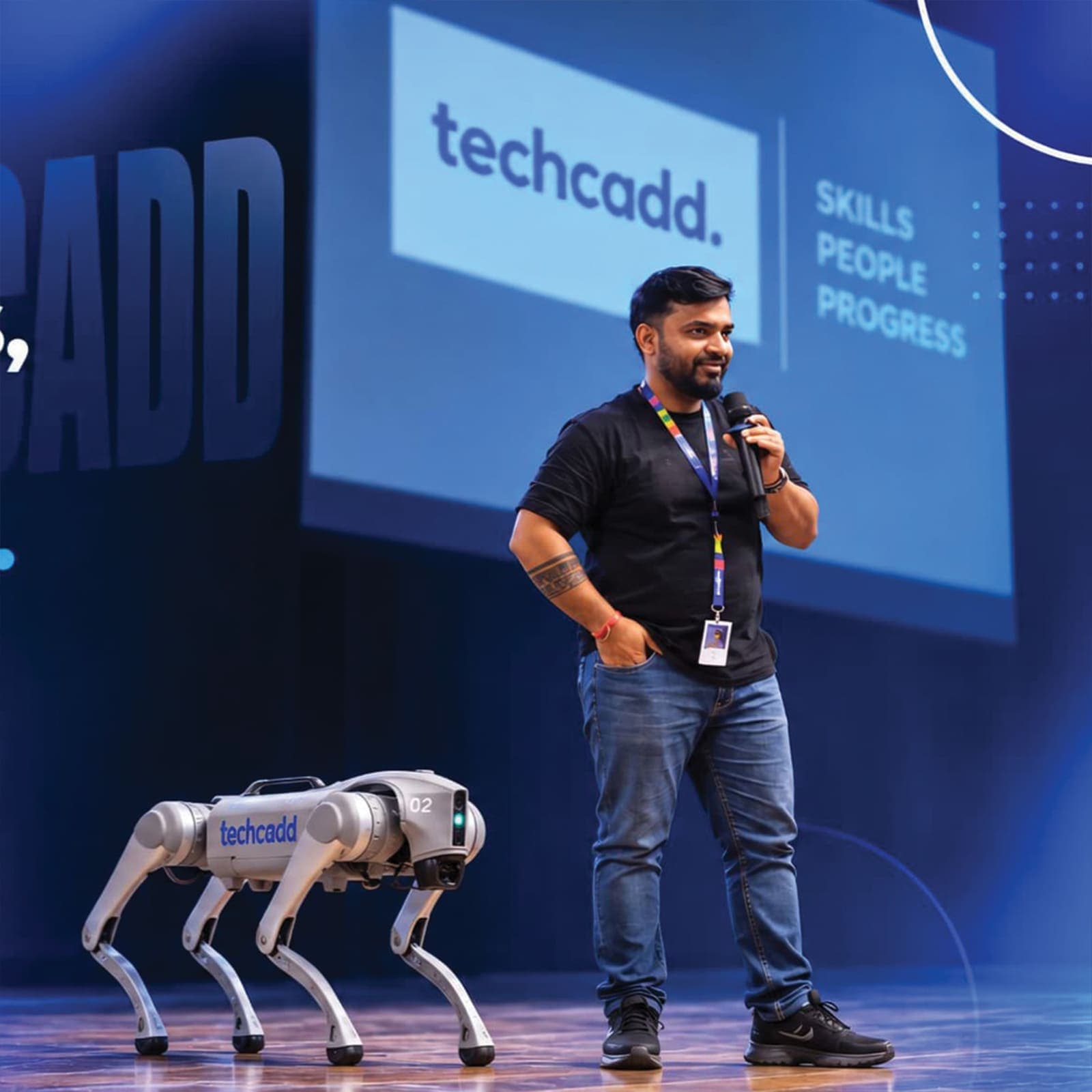 Founder Gourav Gupta on stage with the TechCADD robot dog