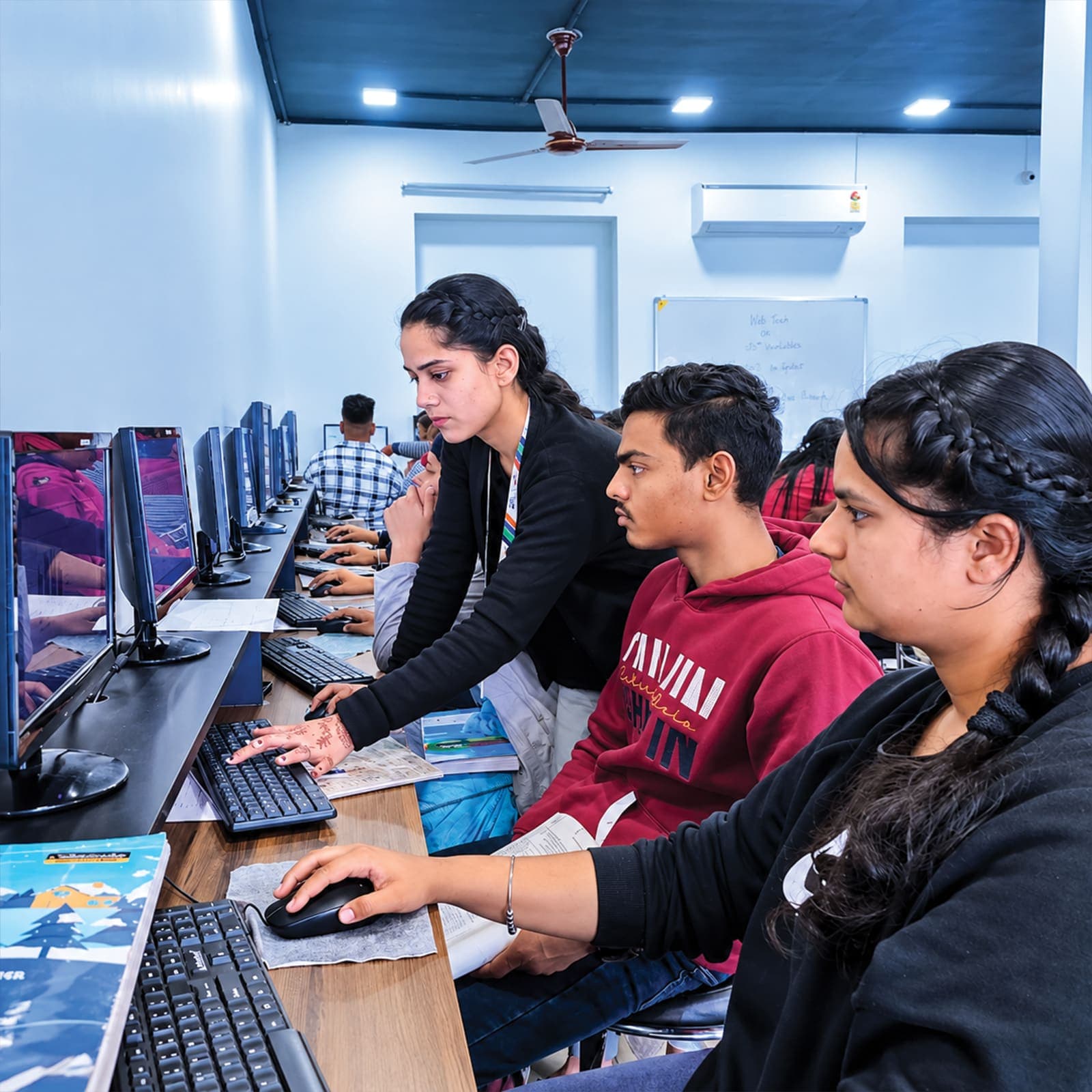 Mentor guiding a student at a computer