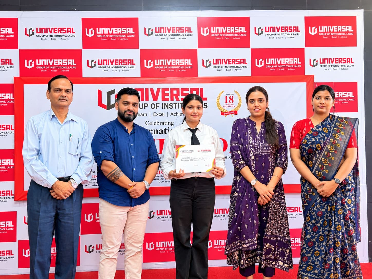 Student receiving a certificate at a college ceremony